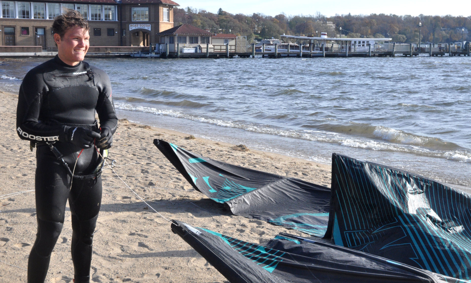 Harry Melges prepares to wrap up his kite boarding equipment after doing some kite boarding on Geneva Lake